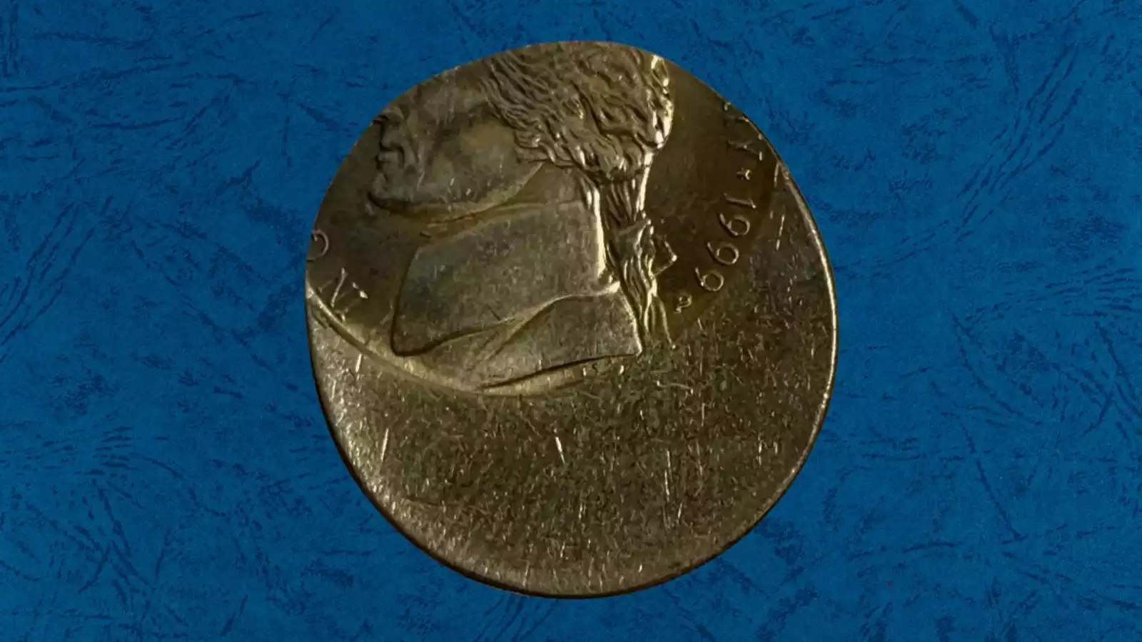 1999 Jefferson nickel with off-center strike showing blank crescent and shifted design elements